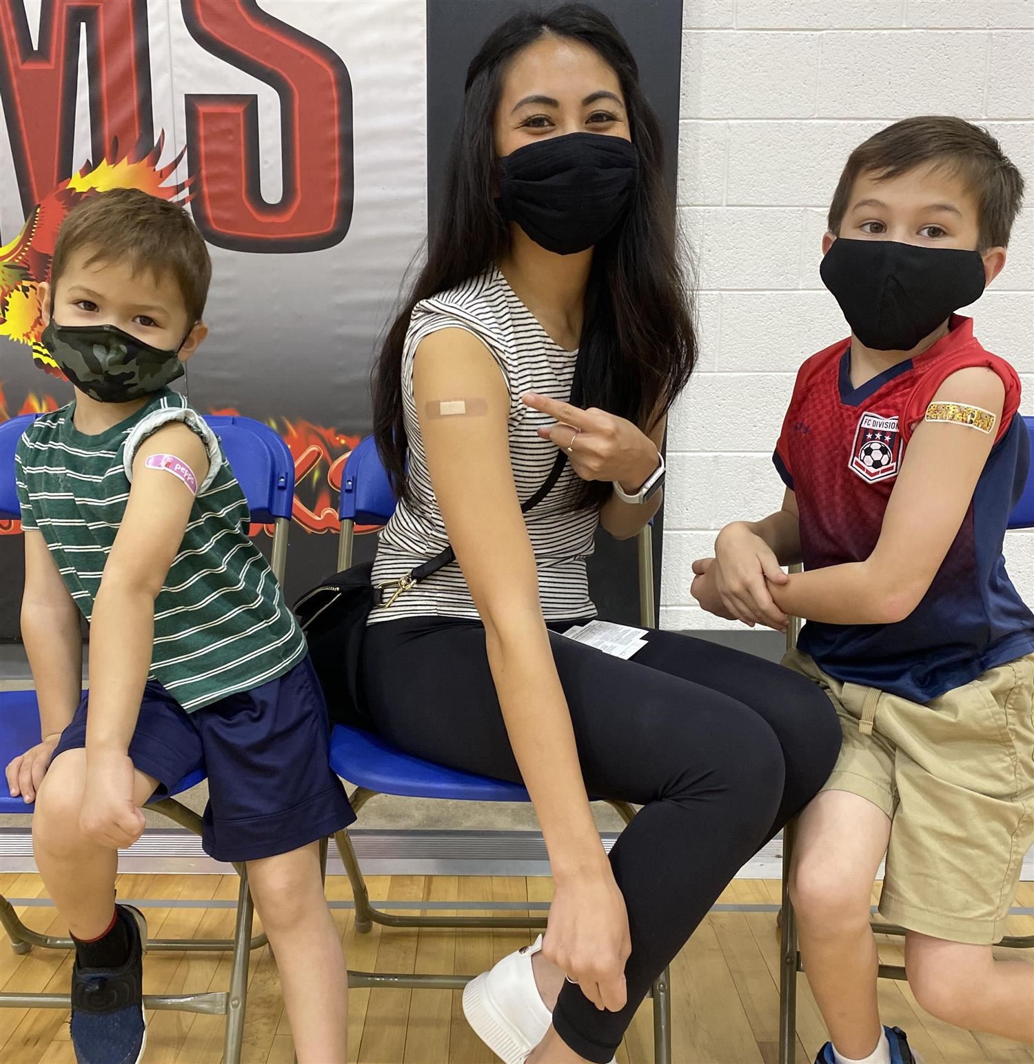 family shows arms after vaccination dose